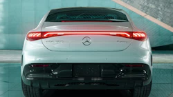 White Mercedes-Benz EQE electric sedan with illuminated rear lights