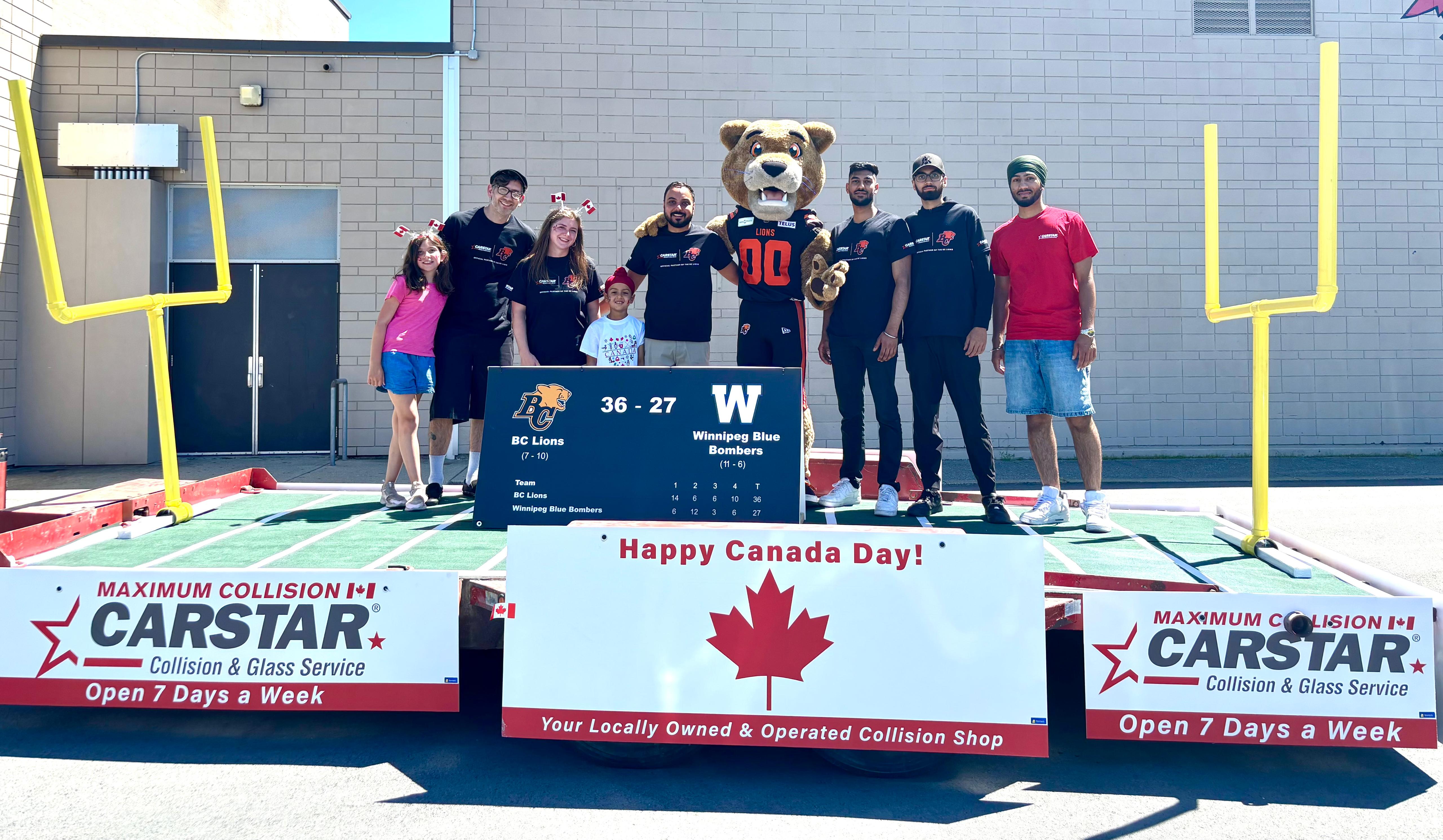 Canada Day celebration with football team, mascot, and CarStar sponsors