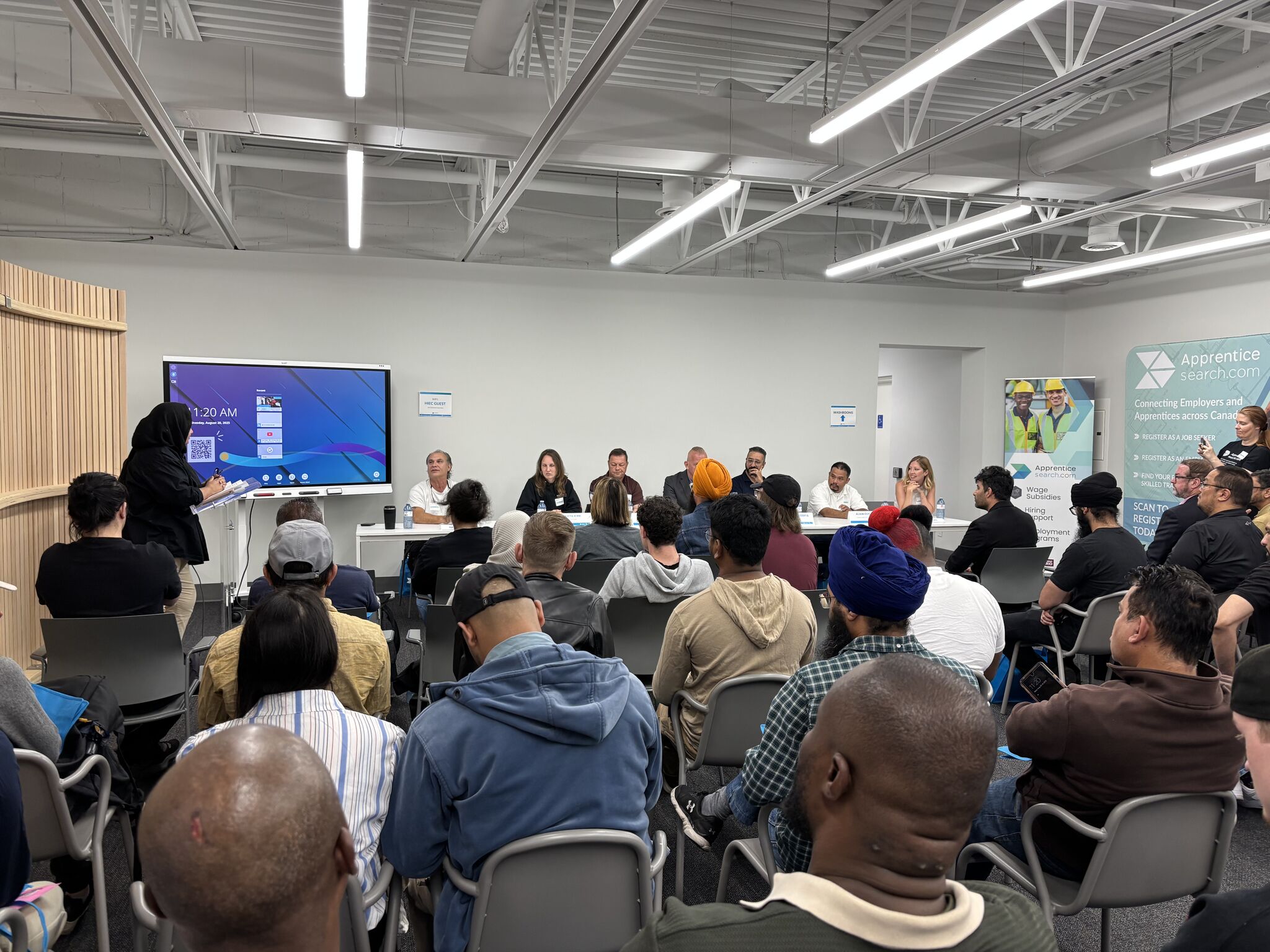 Diverse group attending a professional workshop or training session in a modern conference room