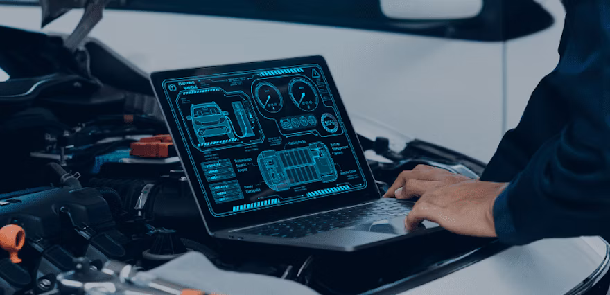 Laptop displaying digital automotive diagnostic interface on vehicle dashboard