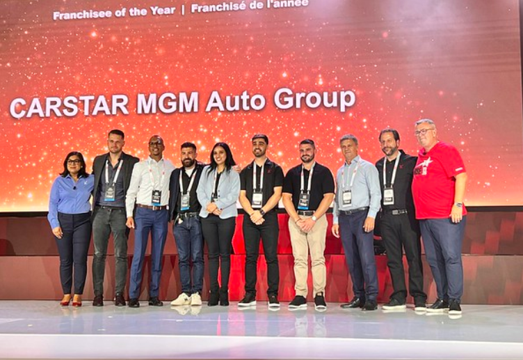CARSTAR MGM Auto Group franchisee award ceremony with team lineup on stage