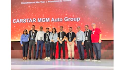 CARSTAR MGM Auto Group franchisee award ceremony with team lineup on stage