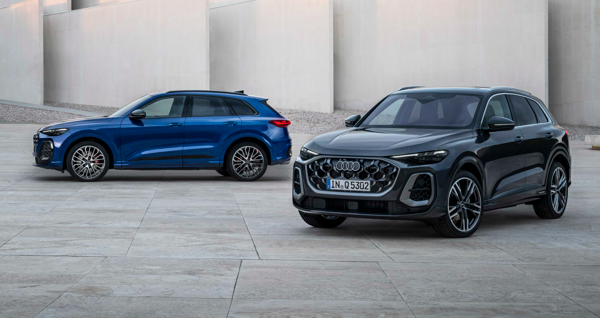 Two Audi SUVs - blue and black - parked on a concrete surface