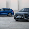 Two Audi SUVs - blue and black - parked on a concrete surface