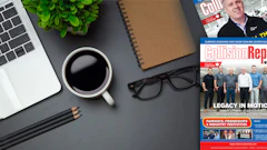 Workspace desk with laptop, coffee, magazine, and office accessories