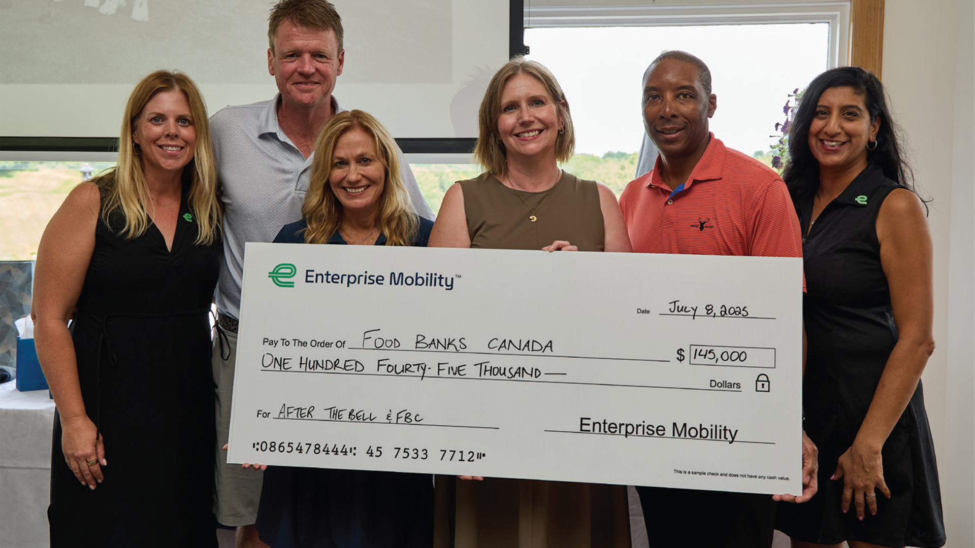 Enterprise Mobility team presenting $145,000 charity donation check