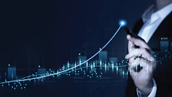 Business professional analyzing upward trending data visualization with digital graph