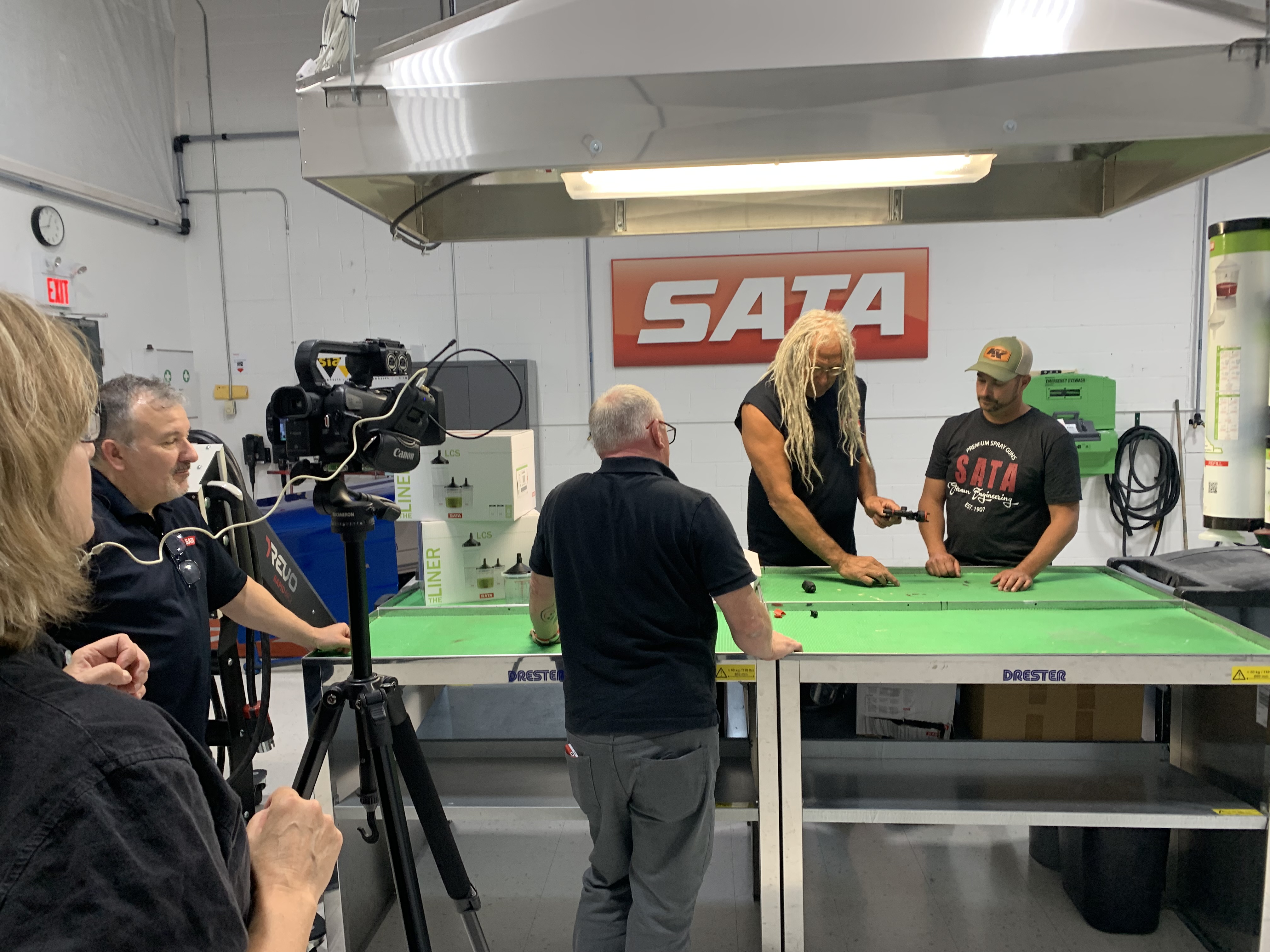 SATA logo on wall during industrial video production with green work table