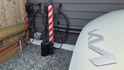 Electric vehicle charging station with white logo and striped charging indicator