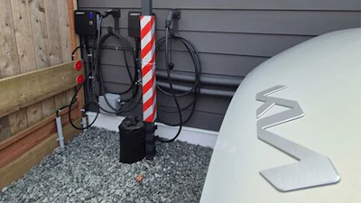 Electric vehicle charging station with white logo and striped charging indicator