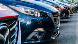 Dark blue Mazda cars lined up in a dealership parking lot