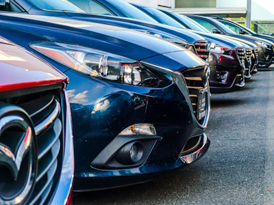 Dark blue Mazda cars lined up in a dealership parking lot