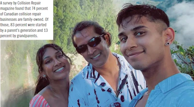 Three smiling family members posing together outdoors with trees in background