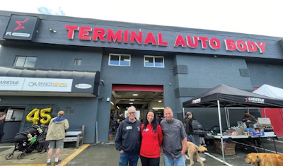 Terminal Auto Body storefront with staff standing outside during community event