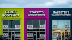 Three auto repair shops with colorful facades advertising job openings