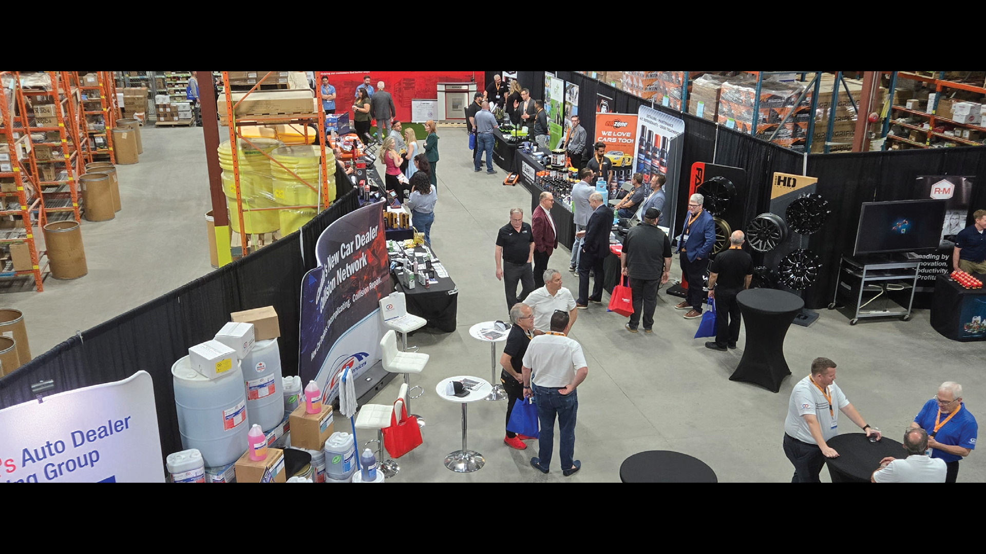 Industrial warehouse trade show with vendor booths and equipment displays