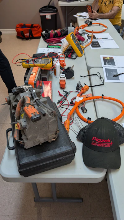 Plazek Auto Recyclers hat near automotive electrical testing equipment