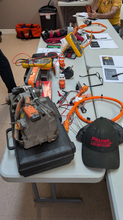 Plazek Auto Recyclers hat near automotive electrical testing equipment