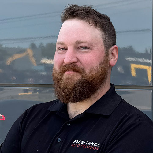 Bearded professional in black Excellence Auto Collision polo shirt