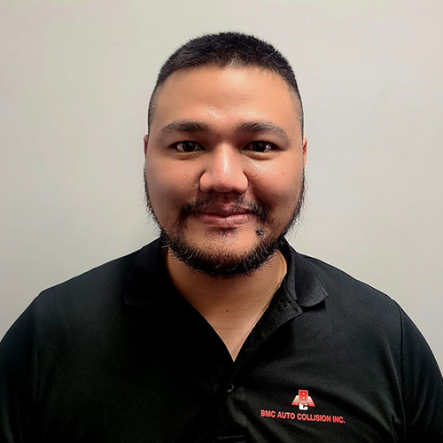 Employee wearing black polo shirt with BMC Auto Collision logo