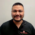 Employee wearing black polo shirt with BMC Auto Collision logo