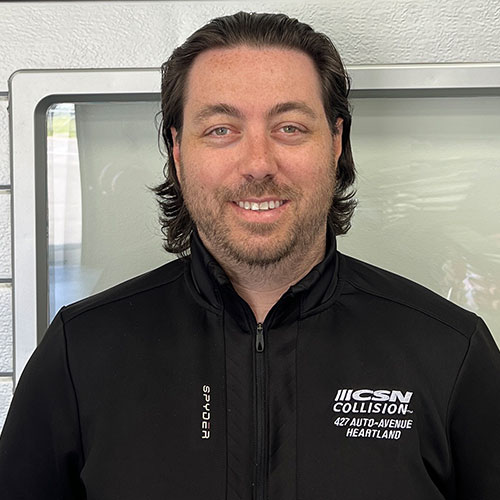Smiling employee in black CSN Collision branded jacket
