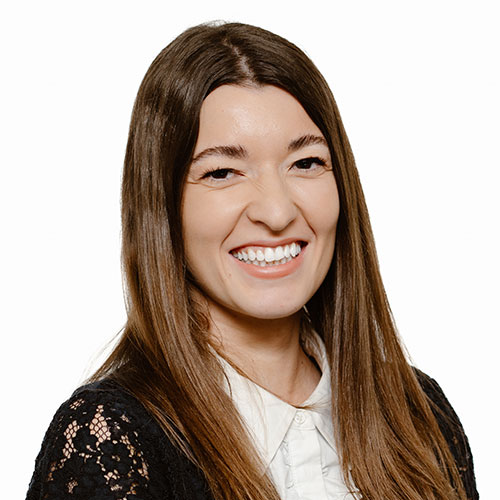 Professional woman in black lace cardigan smiling warmly