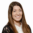 Professional woman in black lace cardigan smiling warmly