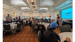 Conference room with attendees and EMAX presentation screen