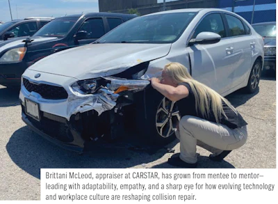 Automotive appraiser examining damaged white car at repair facility