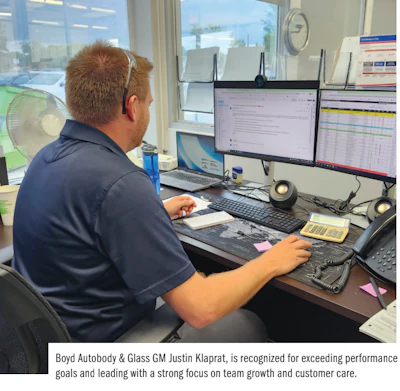 Professional working at computer desk with multiple monitors and office equipment