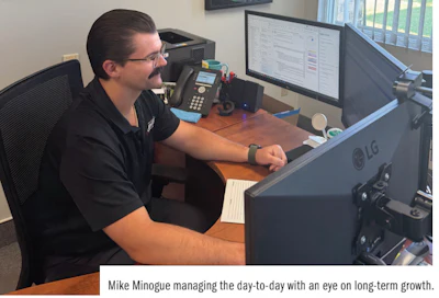 Professional working at desk with computer monitors and office equipment