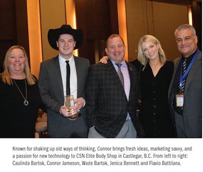 Five professionals at corporate event, one wearing cowboy hat, posing together