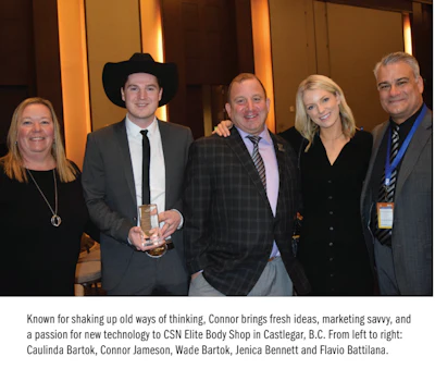 Five professionals at corporate event, one wearing cowboy hat, posing together
