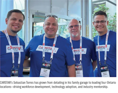Four CARSTAR team members in blue shirts at corporate conference