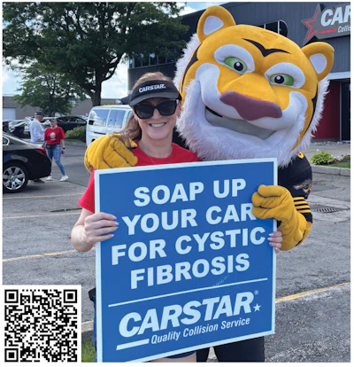 CARSTAR mascot and employee promoting car wash fundraiser for Cystic Fibrosis