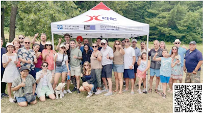 Group photo at outdoor event with GHC branded tent and diverse team members