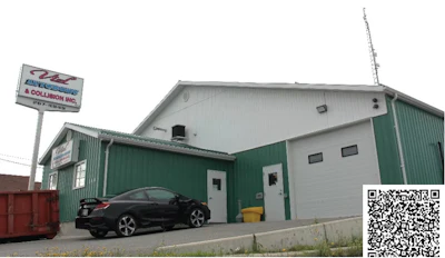 Green and white auto collision repair shop with black vehicle parked outside