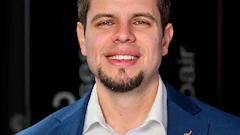 Smiling professional in blue suit jacket with white shirt