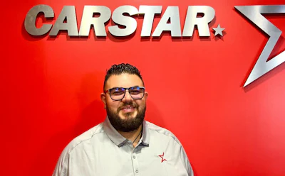 CARSTAR automotive service logo with employee in white shirt
