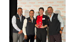 Simplicity corporate event with four professionals and award recipient