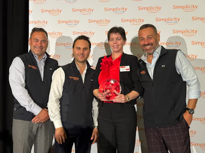 Simplicity corporate event with four professionals and award recipient