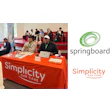 Simplicity Car Care booth with branded orange tablecloth at conference event
