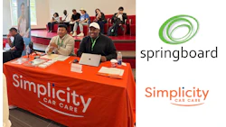 Simplicity Car Care booth with branded orange tablecloth at conference event