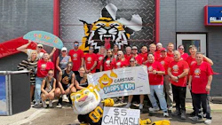 CARSTAR charity car wash event with team in red shirts and mascot