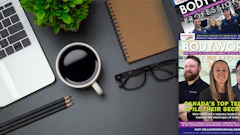 Desktop workspace with laptop, coffee, magazine, plant, and glasses