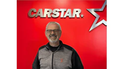 CARSTAR automotive service professional in branded gray and black jacket