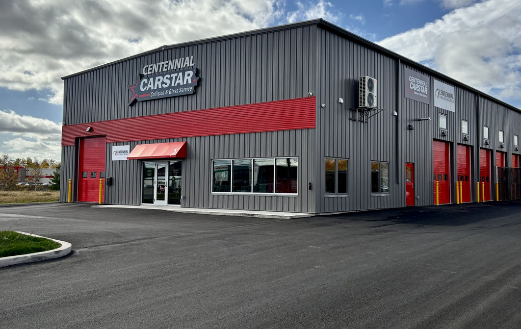Centennial CarStar auto repair shop with gray and red exterior on a clear day