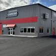 Centennial CarStar auto repair shop with gray and red exterior on a clear day