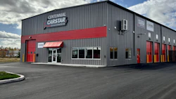 Centennial CarStar auto repair shop with gray and red exterior on a clear day